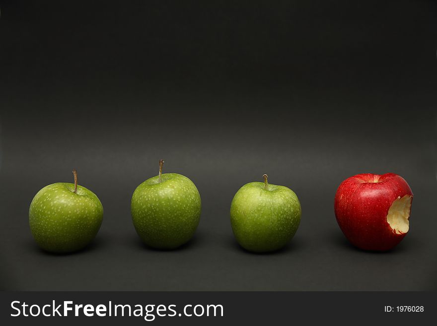 A line of apples with one exception. A line of apples with one exception.