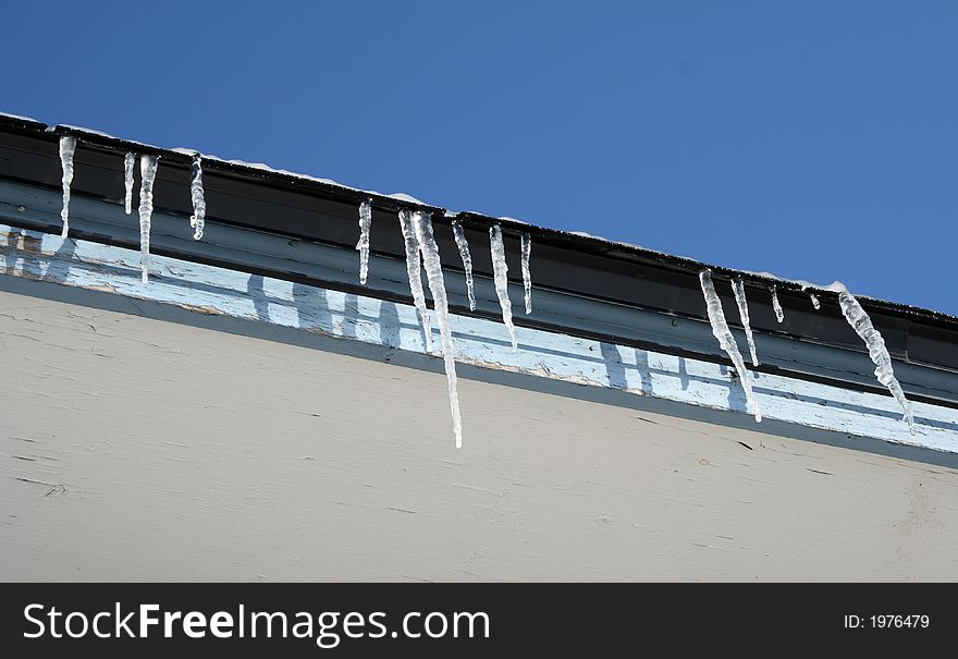 Bright winter day, icicles on the roof