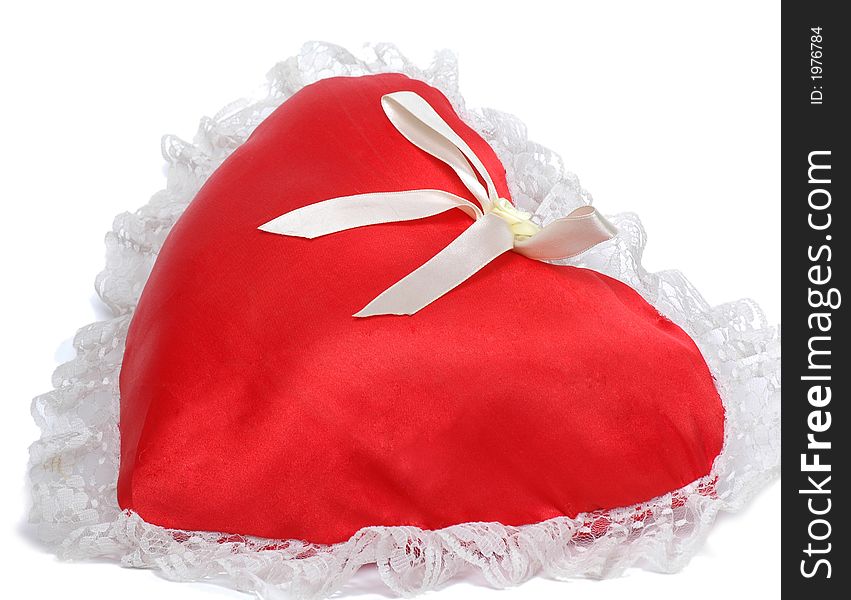 Red pillow as a heart on a white background