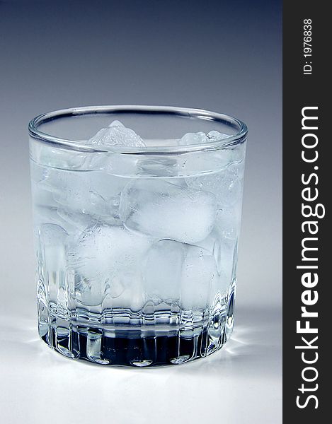 Ice water in a glass with neutral background
