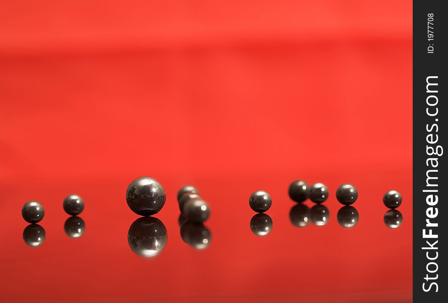 Steel rusty balls on the glass, (studio, halogen light, screen). Steel rusty balls on the glass, (studio, halogen light, screen).