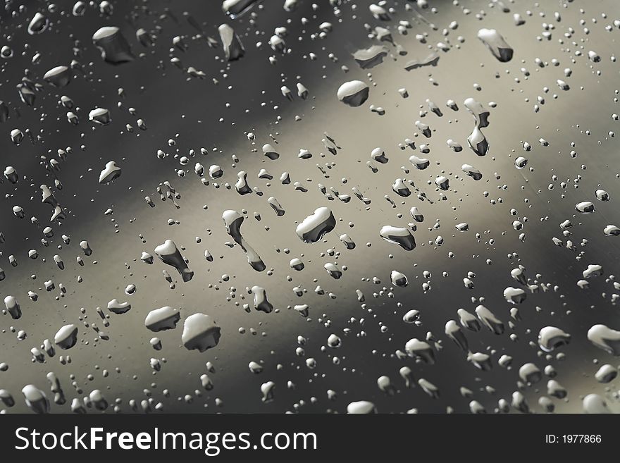 Water drops on the chromium steel sheet, (studio, flash light). Water drops on the chromium steel sheet, (studio, flash light).