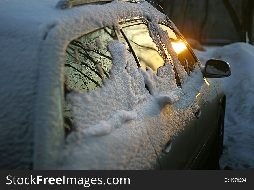 The automobile in snow on a sunset. The automobile in snow on a sunset
