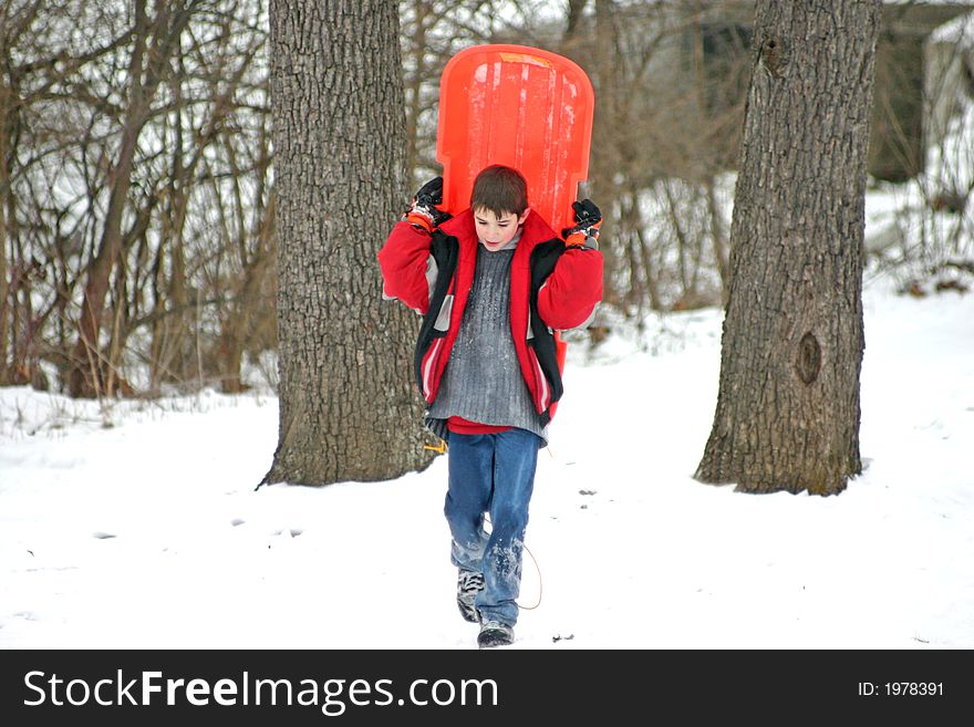 Boy Carrying Sled