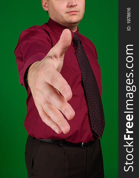 The stretched hand of the businessman in a tie