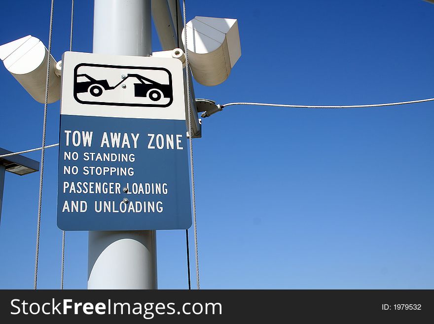 A tow away zone sign at an airport in south Florida