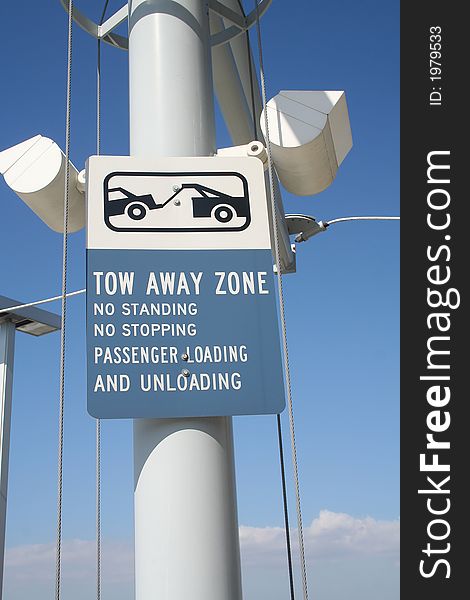 A tow away zone sign at an airport in south Florida
