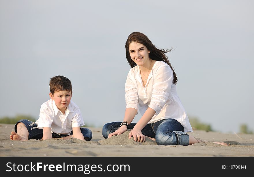 Mom and son relaxing on beach