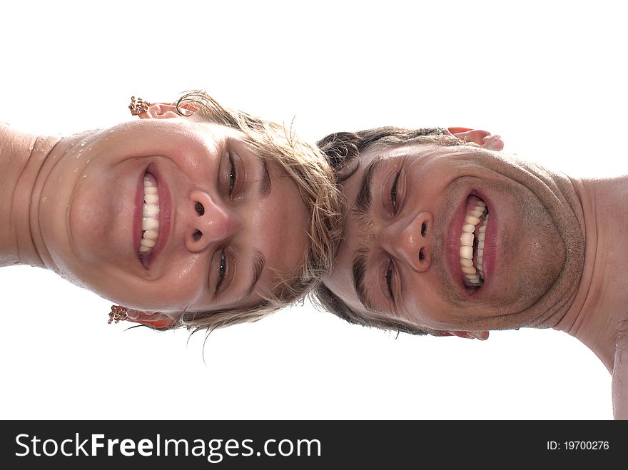 Young happy couple on the beach - closeup from underneath. Young happy couple on the beach - closeup from underneath