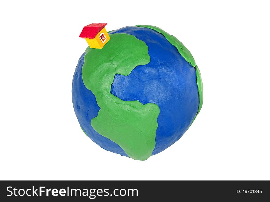 Plasticine globe and toy house on a white background. Plasticine globe and toy house on a white background