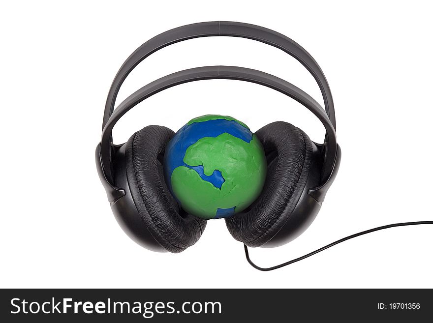 Headphones worn on plasticine globe on a white background. Headphones worn on plasticine globe on a white background
