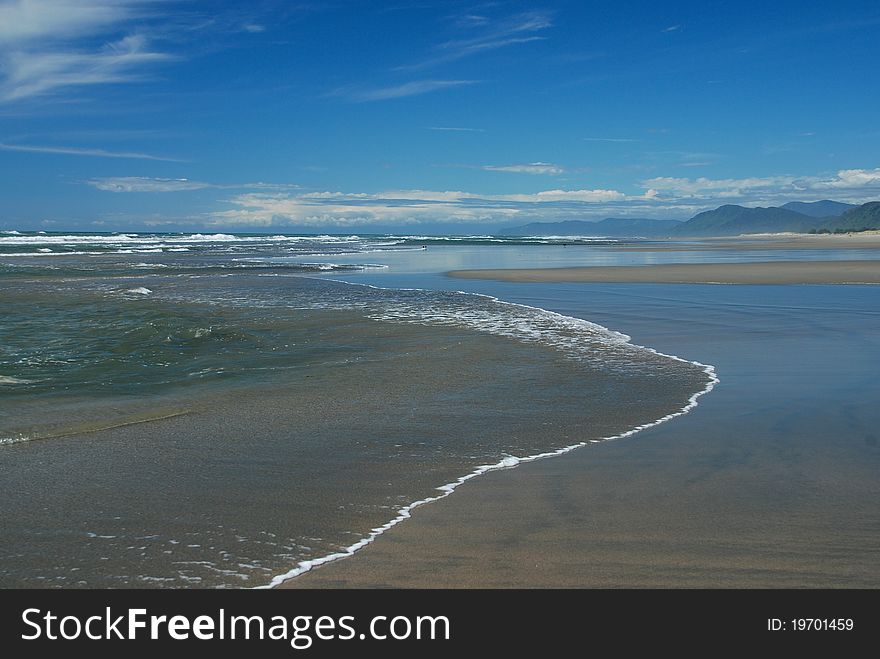 The wild West Coast of New Zealand has some wonderfully wide sandy beaches perfect for walking and playing in the surf. The wild West Coast of New Zealand has some wonderfully wide sandy beaches perfect for walking and playing in the surf