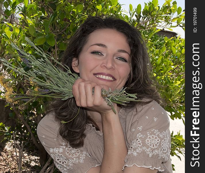 A beautiful young woman and some flowers. A beautiful young woman and some flowers