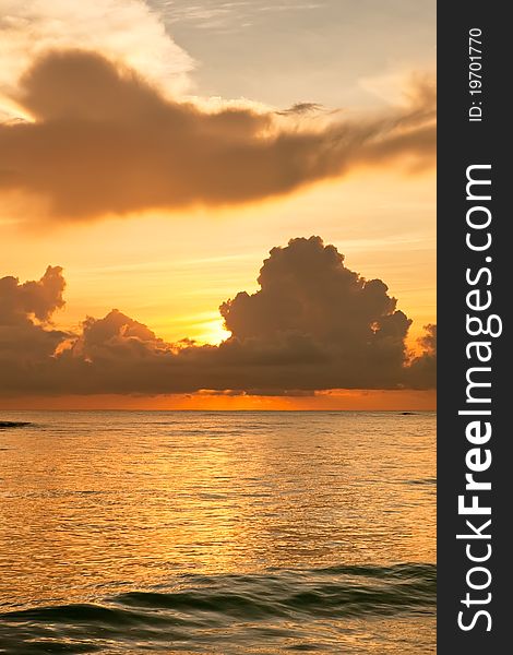 Bright sunrise in early morning with sand beach and ocean in summer