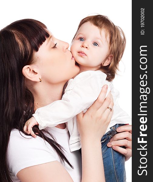 Happy family, young beautiful mother embracing and kissing her daughter, isolated against white background. Happy family, young beautiful mother embracing and kissing her daughter, isolated against white background