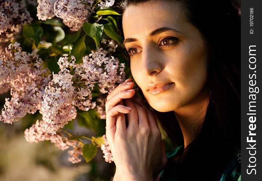 Female portrait with lilac flowers. spring expressions