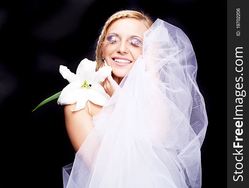 Beautiful young blond woman with a lily and creative makeup. Beautiful young blond woman with a lily and creative makeup