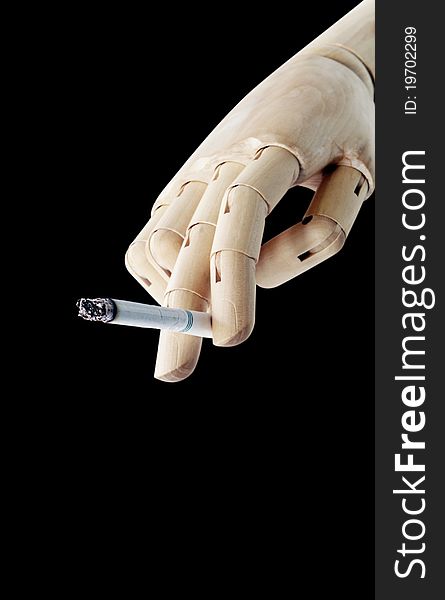 Wooden Hand with cigarette isolated on dark background
