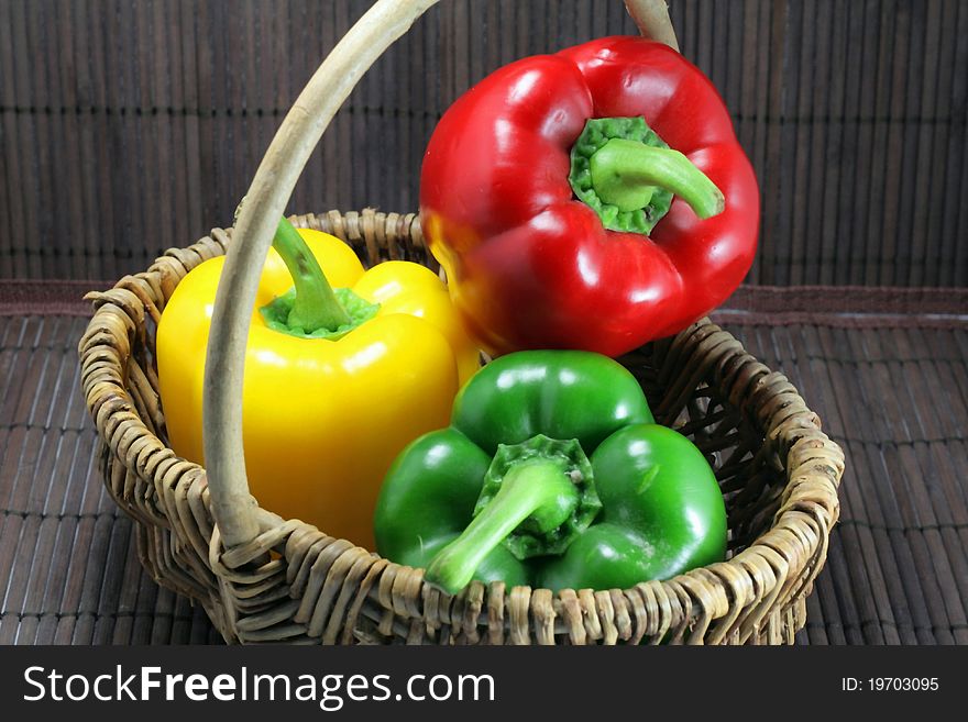 Basket of yellow green red peppers. Basket of yellow green red peppers