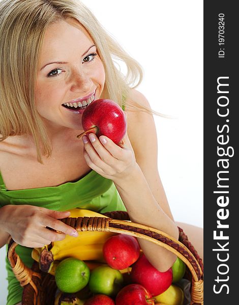 Woman holds a basket of fruit on a white background