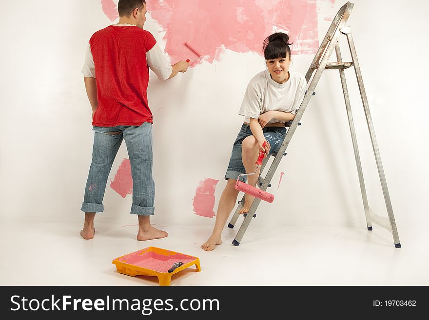 Workers preparing to painting a wall