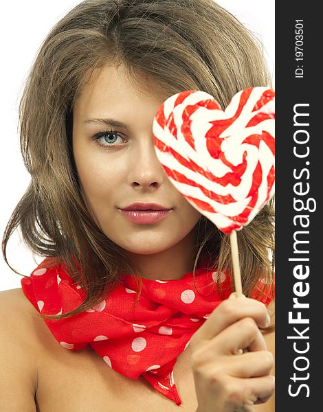 Close-up portrait of young woman with heart shaped lollipop