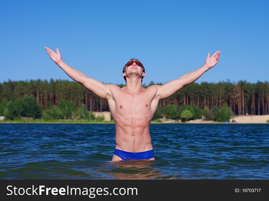 Young Athletic Man Posing In The Water