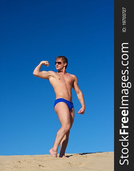 Young athletic man in the water with wearing sunglasses. Young athletic man in the water with wearing sunglasses.