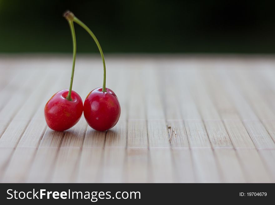 Two cherries on a wooden. Two cherries on a wooden