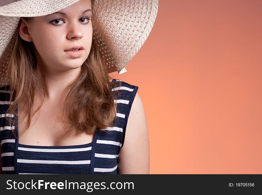 Portrait of a girl wearing a hat with a red background