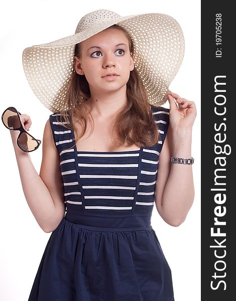 A girl in a straw hat with sunglasses in hand on white background