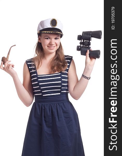 A girl in a sailor cap holding a pair of binoculars and a pipe for smoking on a white background