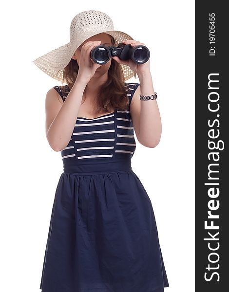 A girl in a big straw hat looking through binoculars on a white background