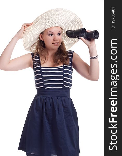 A girl in a big straw hat looking through binoculars on a white background