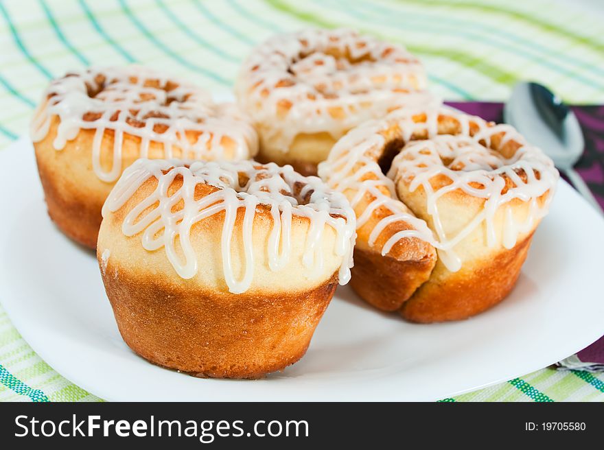 Four rolled muffins with cinnamon and glaze