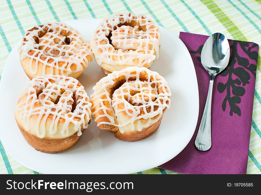 Four rolled muffins with cinnamon and glaze