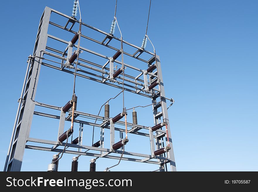 Foreground of an electrical substation with blue sky