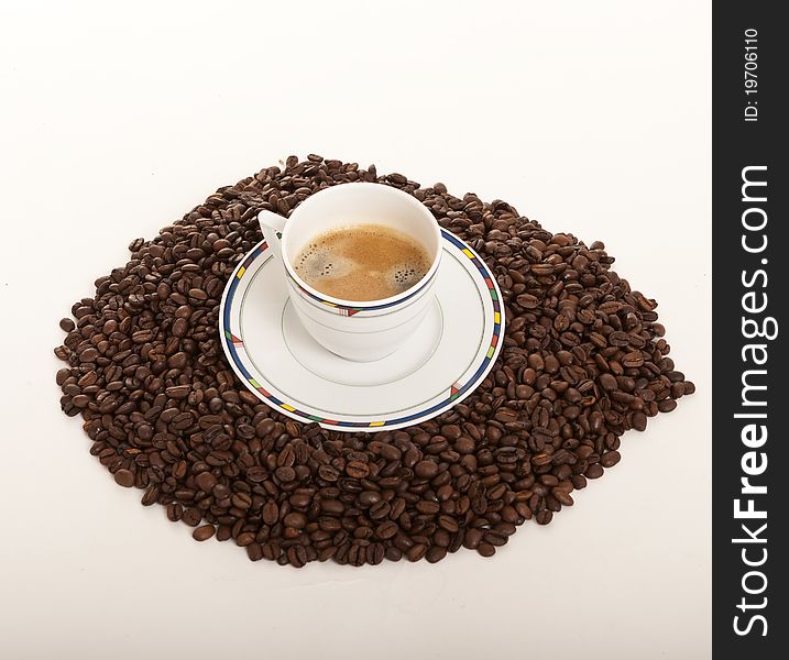 Coffe cup over coffee beans. Coffe cup over coffee beans