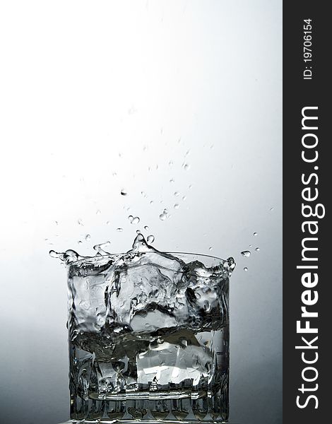 Water splash on glass over the graduated background