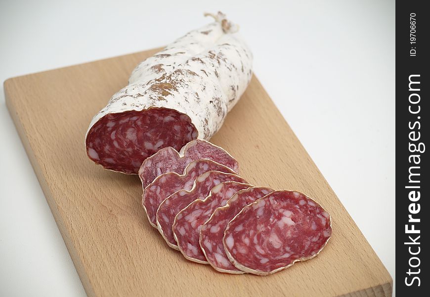 Sausage cut into slices on wooden board. Sausage cut into slices on wooden board.