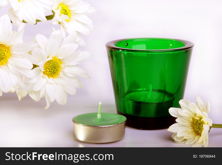 Simple white daisies and two candles with isolated white background