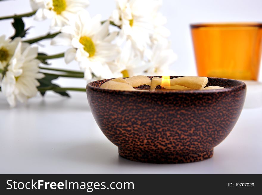 Simple white daisies and candles with isolated white background