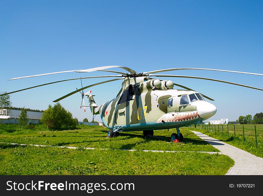 Large helicopter, green grass znd blue sky