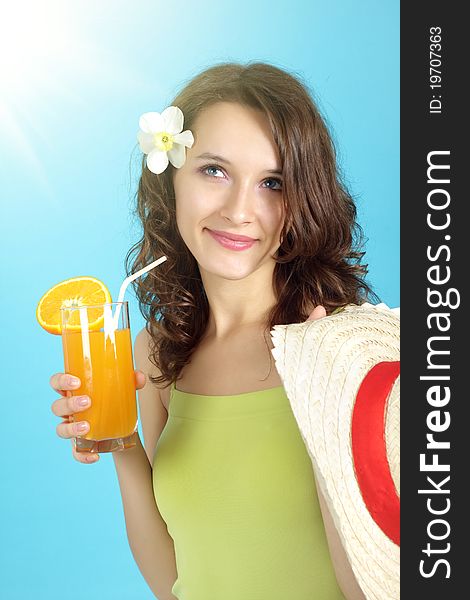 Girl holding a glass of juice on a blue background