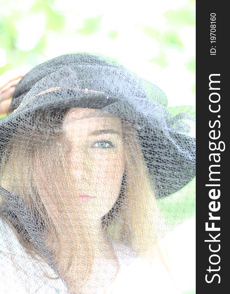 Portrait of the beautiful girl wearing black hat with veil. Portrait of the beautiful girl wearing black hat with veil