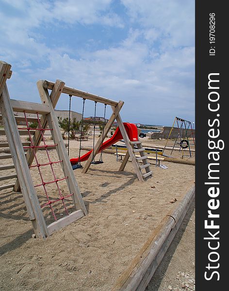 Children's playground decorated in marine style. With cloudy skies in the background.