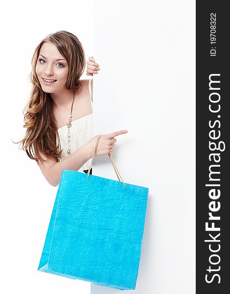 Young girl with shopping bags and empty the board on a white background. Young girl with shopping bags and empty the board on a white background