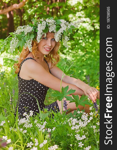 Young woman in wreath from white flowers