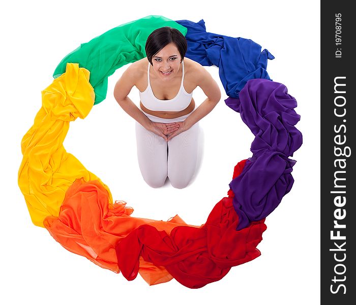 Yong woman doing yoga exercise in rainbow color