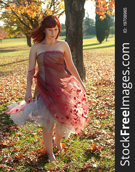 Girl enjoying a stroll in the park on a sunny autumn day. Girl enjoying a stroll in the park on a sunny autumn day